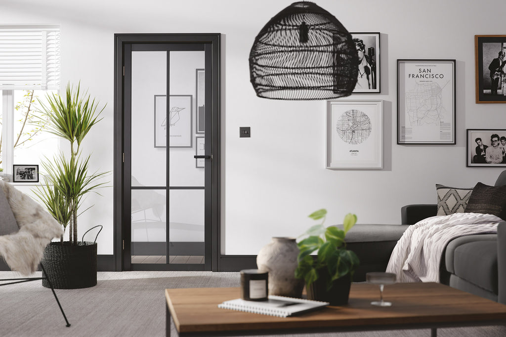 modern black interior door with slim vertical and horizontal bars. Door has a large glass panel with glazing bars